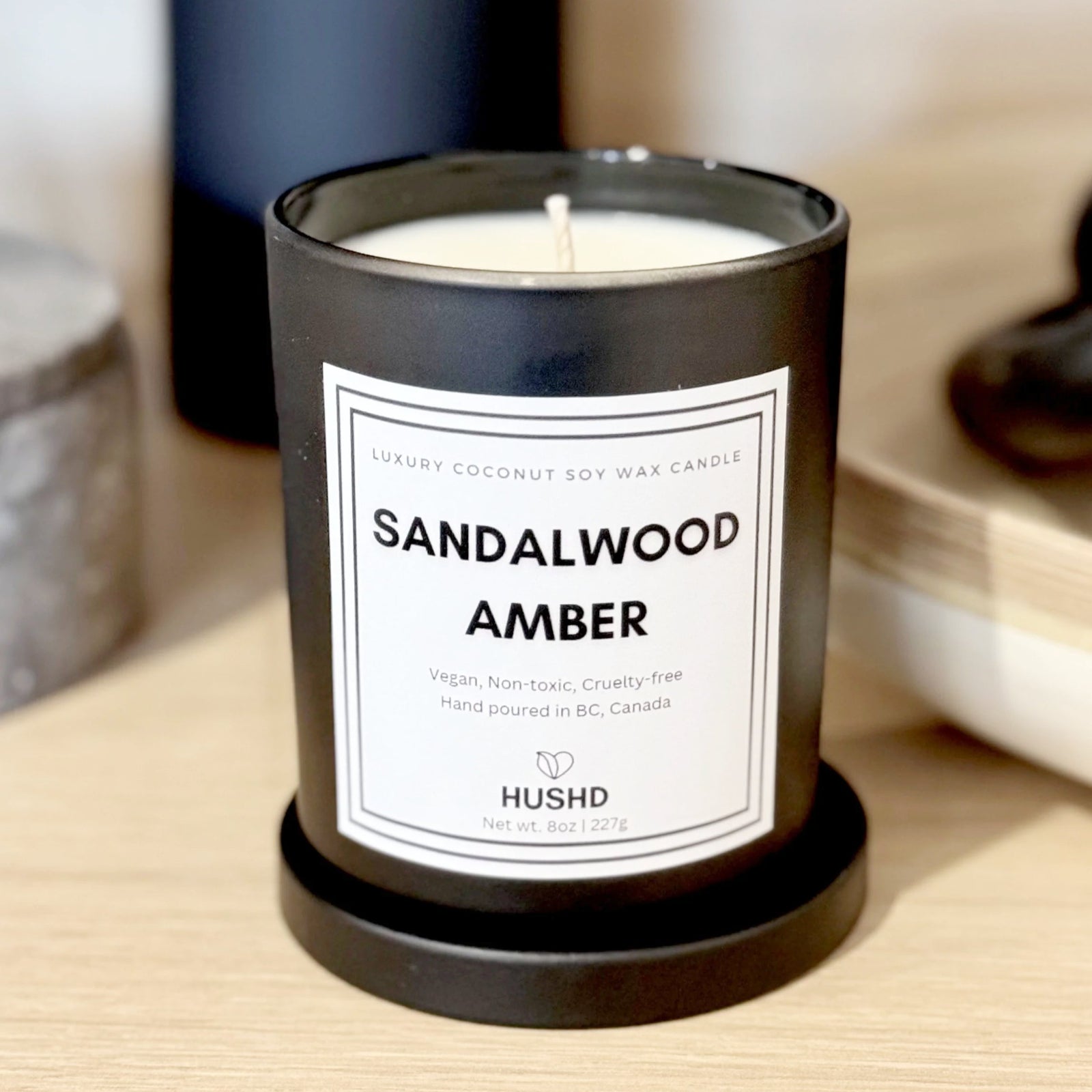 Hand-poured luxury candle with sandalwood and amber scent. Made in Vancouver, Canada. 